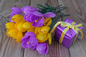 Bouquet of crocuses and gift box