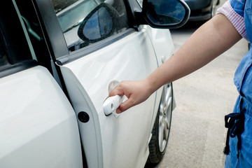 Close-up woman hand open car door