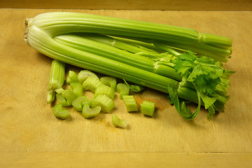 Bunch of fresh green celery on pastry board