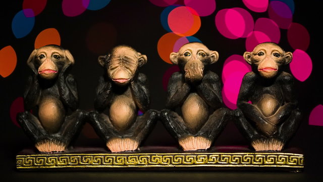 Focus adjusted on a figure four symbolic monkeys on bokeh background