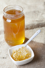 honey with honeycomb on wooden table