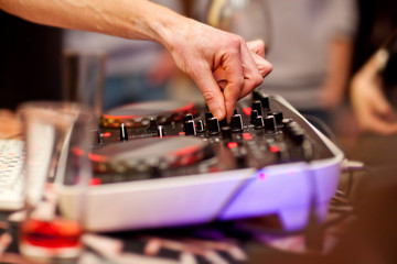 DJ mixing music on console at the night club