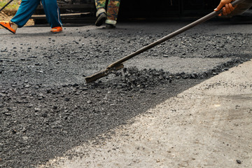 Asphalt spreader in work on site.