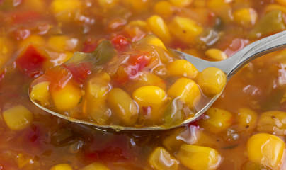 Very close view of corn relish on a spoon