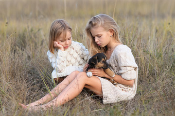 portrait of two girls of girlfriends on a summer nature