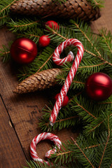 Christmas tree branch, candy, cones, balls on the background of