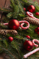 Christmas tree branch, candy, cones, balls on the background of