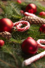 Christmas tree branch, candy, cones, balls on the background of