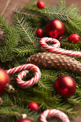 Christmas tree branch, candy, cones, balls on the background of