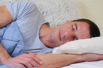 Sleeping man: Young handsome man sleeping in bed