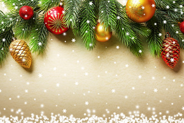 Christmas fir tree branches with toys on paper background