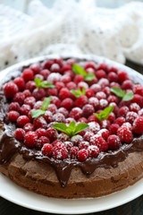 Cake with Chocolate Glaze and raspberries on wooden background