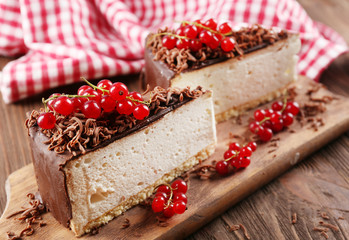 Delicious cheesecake with berries on table close up