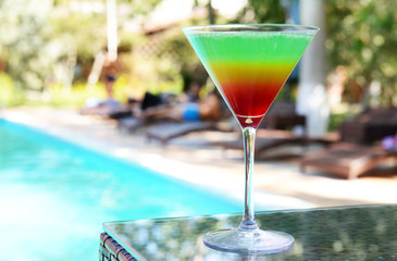 Cocktail on swimming pool background