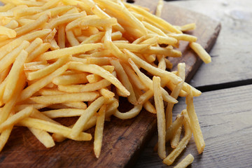 French fried potatoes on cutting board
