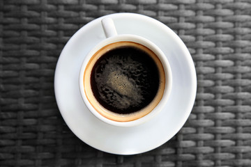 Cup of tasty coffee on table