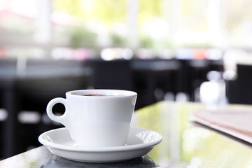 Cup of tasty coffee and newspapers in cafe