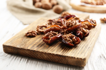 Walnut in date fruit on cutting board, close-up