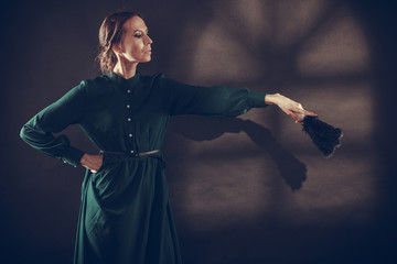 Vintage lady with feather fan on dark