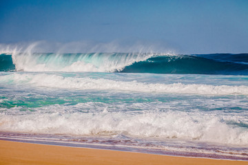 Surfing waves at Bonzai Pipeline on Oahu's North Shore in Hawaii