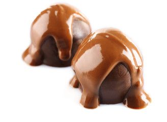 Chocolate poured on candy isolated on white