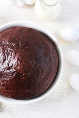 Cooked chocolate pie in a baking tray on a table, top view