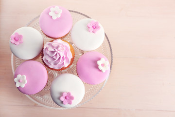 Tasty cupcake on stand, close-up