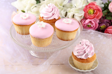 Tasty cupcakes on bright background