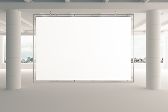 Blank billboard in empty white office with pillars and city view