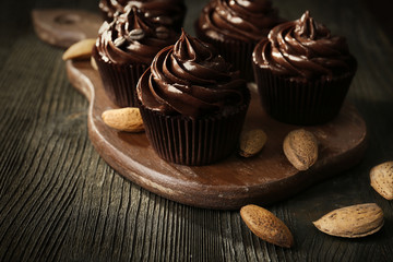 Chocolate cupcakes with nuts on cutting board