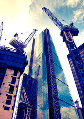 LONDON, UK - DECEMBER 19, 2014: Building site with cranes in the City of London business.