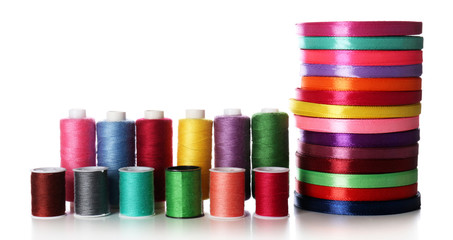Spools of color ribbon and thread, isolated on white