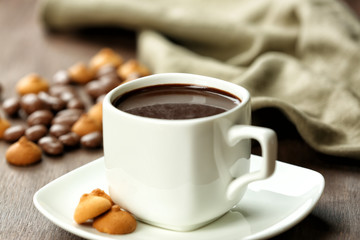 Cup of cacao with biscuits on wooden background