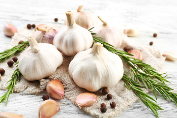 Composition of garlic and rosemary on wooden background