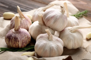 Composition of garlic and rosemary on the paper, close up