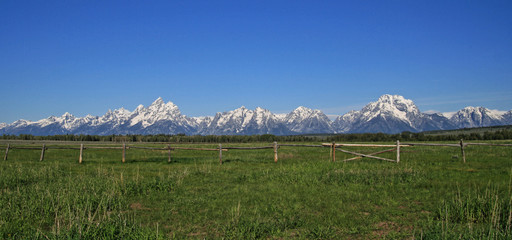 Grand Tetons Mountain Range with split rail fence in foreground