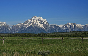 Mount Moran of the Grand Tetons Mountain Range with split rail fence in foreground