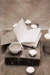 Artwork in vintage style, china tea, notebook, candles