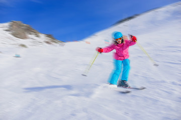 Girl skier in winter resort