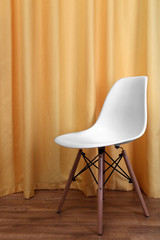 White chair on a curtain background