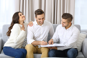 Estate agent meeting with happy couple, on light background