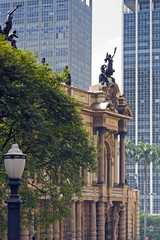 Fototapeta premium The ancient theater in contrast to modern buildings