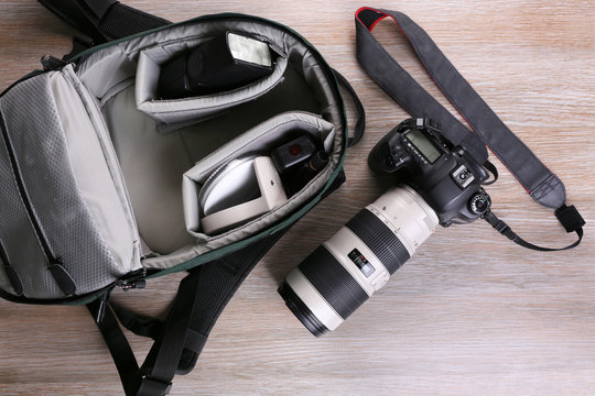 Photographer's equipment on a light wooden background