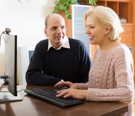 Senior couple talking with someone