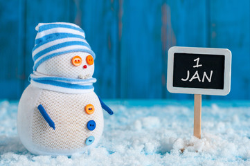 Signpost of the 1 January and two Snowman with red sled, gift stand near direction sign. Happy new year postcard