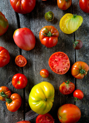 assorted tomatoes on wooden surface