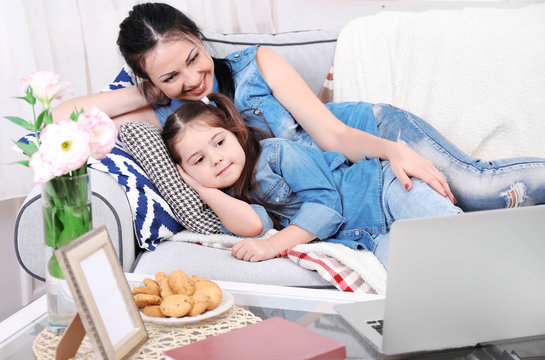 Mother And Daughter Watching Cartoons