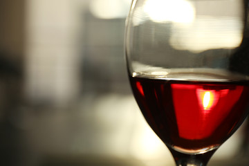 Glass of red wine on blurred background