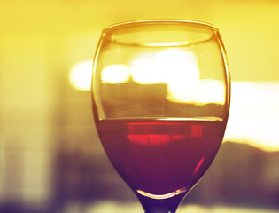 Glass of red wine on blurred background