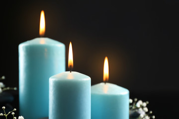 Fototapeta na wymiar Blue burning candles closeup
